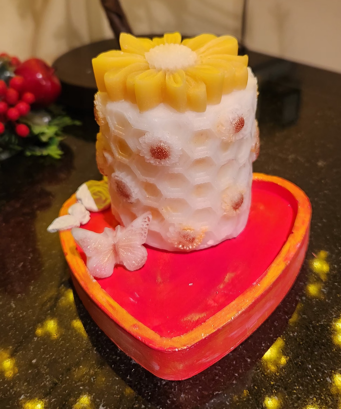 Decorative beewax candle with floral design on a heart-shaped tray