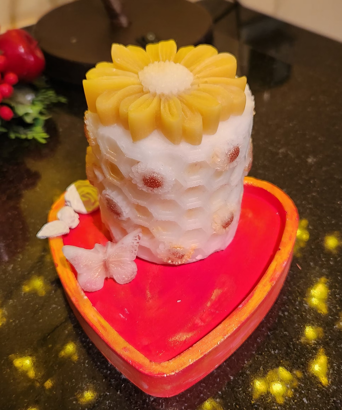 Decorative candle with sunflower design on a heart-shaped tray